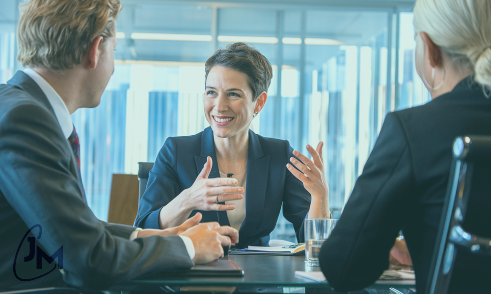 Female executive demonstrating strong and kind leadership during a team meeting.